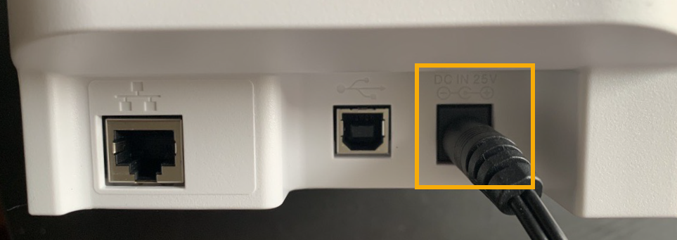 Rear of the Brother QL-820NWBc label printer with the AC adapter port highlighted.